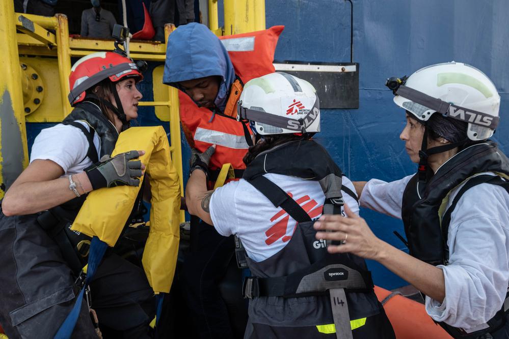 MSF team members help an injured survivor board the ship during a rescue operation. (Geo Barents, January 2023, @Nyancho NwaNri)