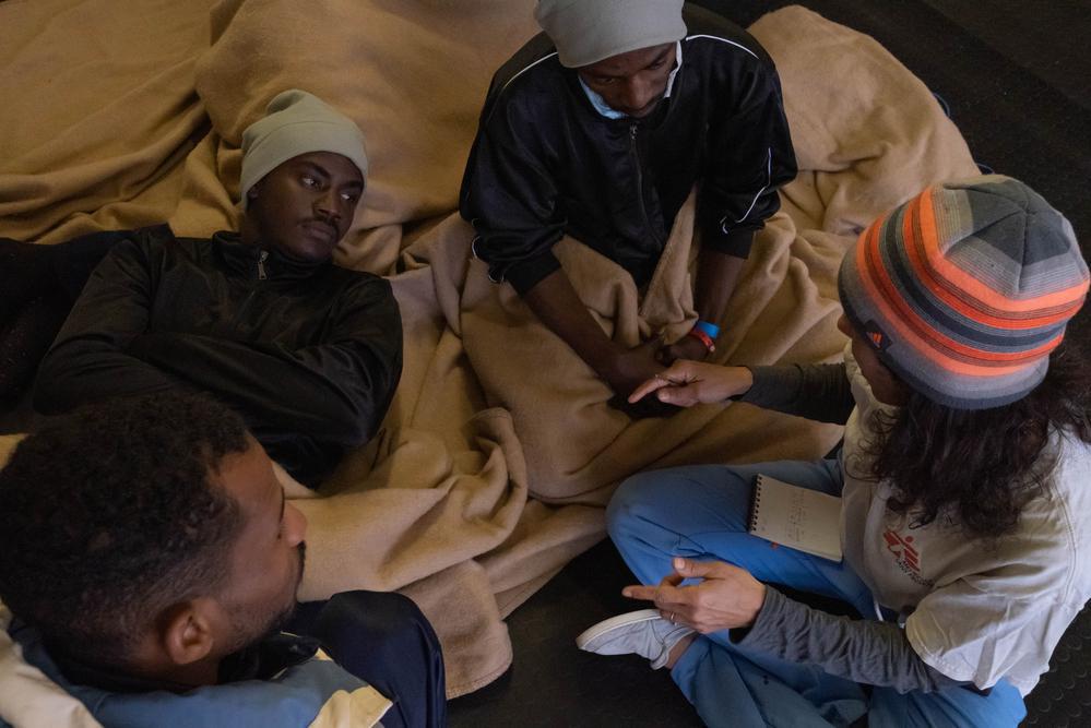 Cultural mediator converses with some survivors, answers their questions and provides them with much needed advice, support and encouragement. (Geo Barents, January 2023, @Nyancho NwaNri)